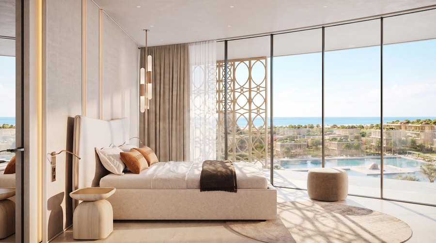 A bedroom with full-height glazing to the terrace
